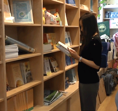 Student perusing books at MUM bookstore